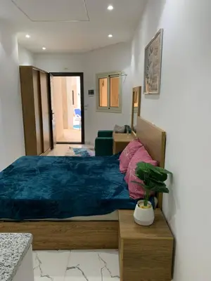 a bedroom with a large bed with a blue blanket at Sea Light Arabia in Hurghada
