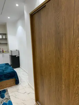 a wooden door in a room with a bed at Sea Light Arabia in Hurghada
