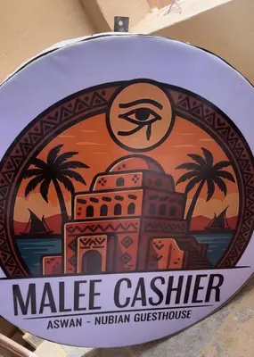 a sign for a market center with an image of an eye at malee cashie in Aswan