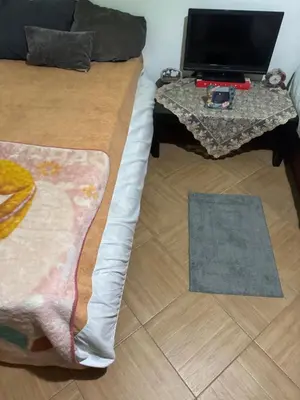 a bedroom with a bed and a table with a laptop on it at apartment 20 in Hurghada