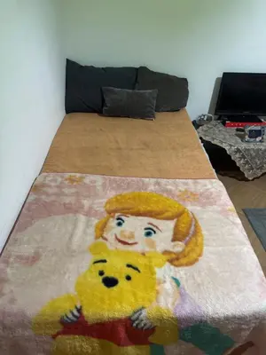 a bed with a picture of a child on it at apartment 20 in Hurghada