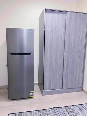 a stainless steel refrigerator sitting next to a door at Princess Resort Hurghada in Hurghada