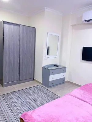 a bedroom with a pink bed and a dresser and a mirror at Princess Resort Hurghada in Hurghada