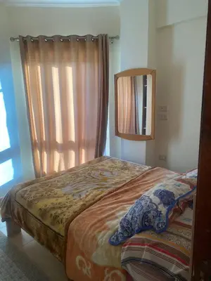 a bedroom with a bed with a mirror and a window at Princess Resort Hurghada in Hurghada