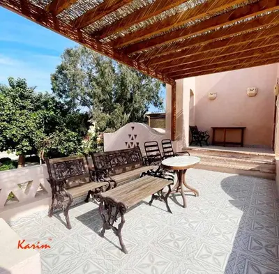 a patio with two benches and a table on a patio at Studio For Rent in El Gouna Kafr in Hurghada