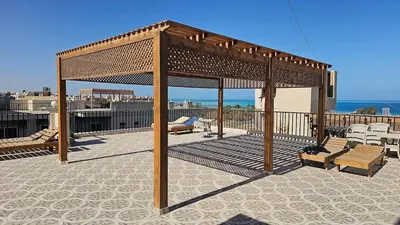 a gazebo on a patio with a view of the ocean at Apartment 95sqm with sea view in Hurghada