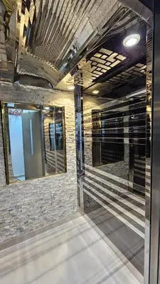 a room with two mirrors and a brick wall at Apartment 95sqm with sea view in Hurghada