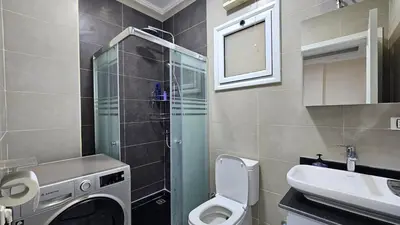 a bathroom with a washing machine and a sink at Apartment 95sqm with sea view in Hurghada