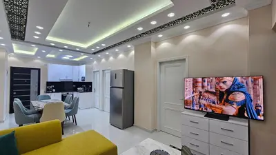 a living room with a flat screen tv on a wall at Apartment 95sqm with sea view in Hurghada