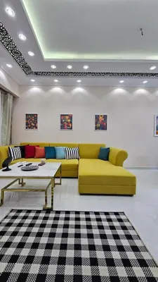 a living room with a yellow couch and a table at Apartment 95sqm with sea view in Hurghada