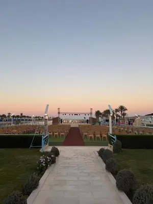 a pathway leading to an outdoor wedding with tables and chairs at Studio in gravity hotel & aquapark hurghada in Hurghada