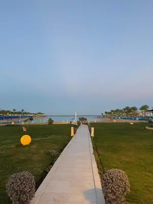 a walkway leading to the beach with an orange frisbee at Studio in gravity hotel & aquapark hurghada in Hurghada