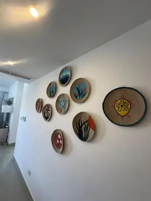 a wall with a bunch of plates on a wall at Refined Two-Bedroom with Pool View Gcribs ElGouna in El Gouna
