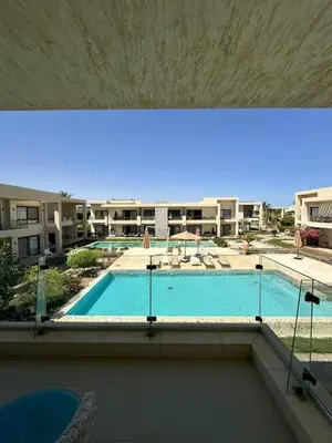 a view of a swimming pool in a building at Refined Two-Bedroom with Pool View Gcribs ElGouna in El Gouna