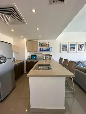 a kitchen with a refrigerator and a counter top at Refined Two-Bedroom with Pool View Gcribs ElGouna in El Gouna