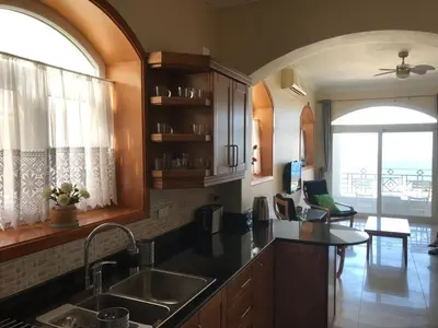 a kitchen with a sink and a table in a room at One bedroom apartment with stunning sea view in Hurghada