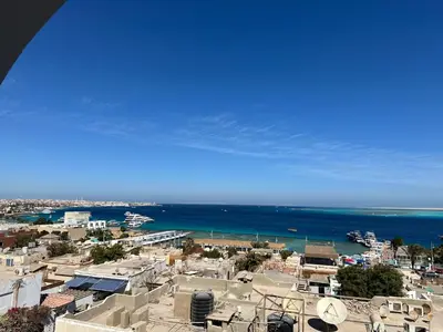 a view of a city and the ocean at One bedroom apartment with stunning sea view in Hurghada