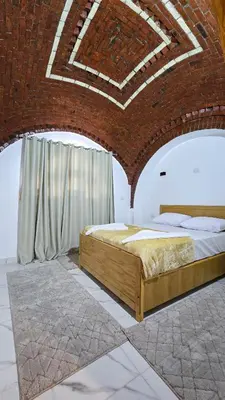 a bedroom with a bed in a brick wall at Hepton hotel
