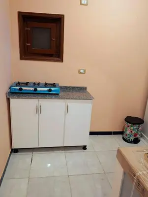 a kitchen with a stove top on a counter at Lutos flower apartment 2 in Al Karnak
