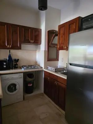 a kitchen with a stainless steel refrigerator and a dishwasher at Westgolf Y62 in Hurghada