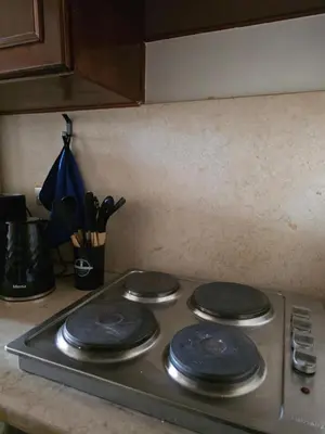 a stove top with four black burners on it at Westgolf Y62 in Hurghada