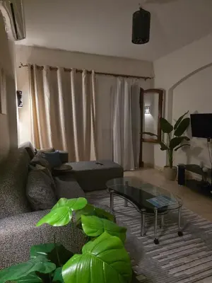 a living room with a couch and a glass table at Westgolf Y62 in Hurghada