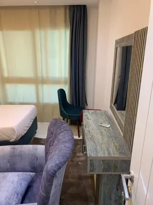 a hotel room with a bed and a couch and a table at Elegant 3BR Luxury Suite - Fanadir Bay in Hurghada