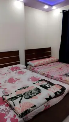 a bedroom with two beds with a blanket on them at Apartment in sherry street near sheraton in Hurghada