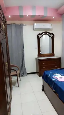 a bedroom with a mirror and a bed and a dresser at Apartment in sherry street near sheraton in Hurghada