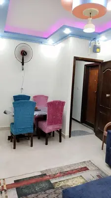 a dining room with two chairs and a table at Apartment in sherry street near sheraton in Hurghada