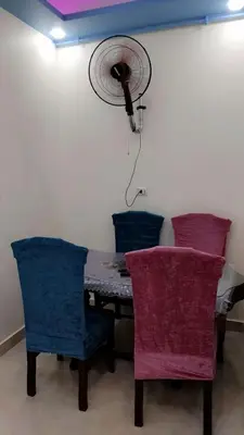 a room with a table with chairs and a fan at Apartment in sherry street near sheraton in Hurghada