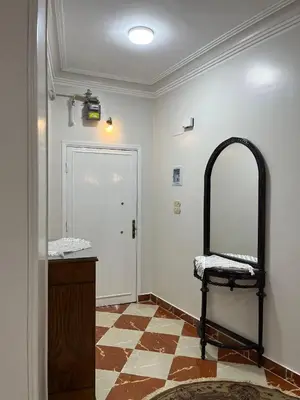 a dressing room with a mirror and a chair at Dahabiya Apartment in Luxor
