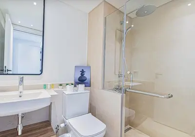 a bathroom with a shower and a toilet and a sink at Stylishly furnished and quietly located apartment in Hurghada