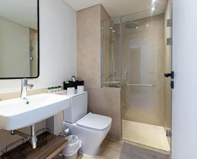 a bathroom with a toilet and a sink and a shower at Stylishly furnished and quietly located apartment in Hurghada