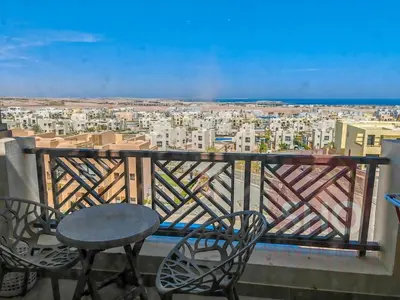 a balcony with a table and chairs and a view at Best view in Makadi bay private rooftop PHASE 2 Makadi Heights in Hurghada