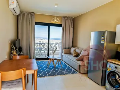 a living room with a couch and a table at Best view in Makadi bay private rooftop PHASE 2 Makadi Heights in Hurghada