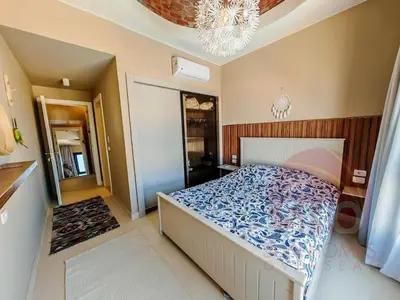 a bedroom with a bed and a chandelier at Best view in Makadi bay private rooftop PHASE 2 Makadi Heights in Hurghada