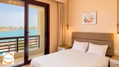 a bedroom with a bed and a view of the ocean at Ancient Sands 4BR Villa Heated pool in El Gouna