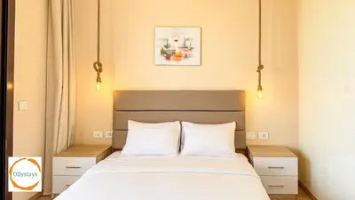 a bedroom with a bed with two white pillows at Ancient Sands 4BR Villa Heated pool in El Gouna