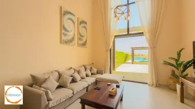 a living room with a couch and a table at Ancient Sands 4BR Villa Heated pool in El Gouna