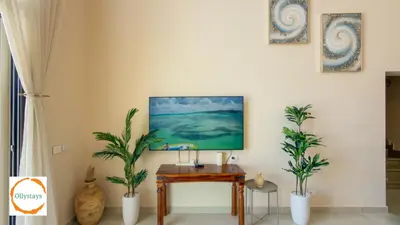 a living room with a table and two plants at Ancient Sands 4BR Villa Heated pool in El Gouna