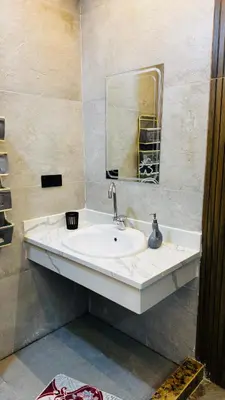 a bathroom with a white sink and a mirror at Magwish in Hurghada