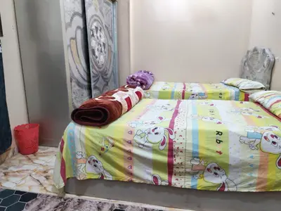 a bedroom with a bed with a hello kitty comforter at روف كناريا in Luxor