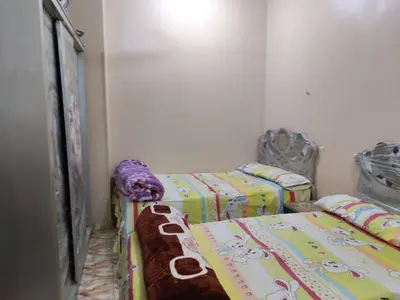 a room with two twin beds in a room at روف كناريا in Luxor