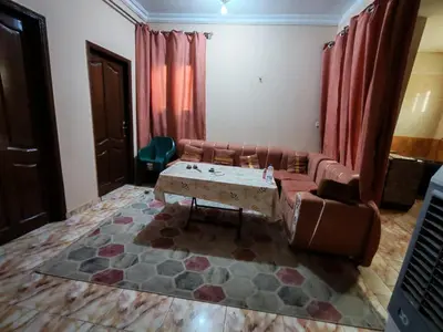 a living room with a couch and a table at روف كناريا in Luxor