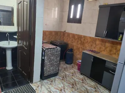 a small kitchen with a sink and a sink at روف كناريا in Luxor