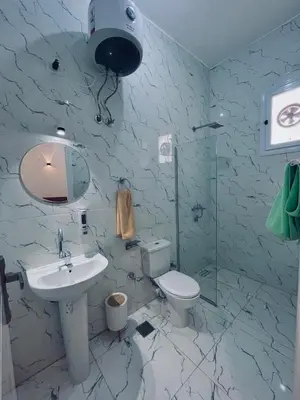 a bathroom with a sink and a toilet at Farah Hotel in Al Aqālitah