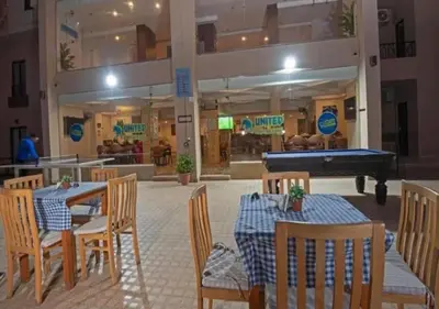 a restaurant with a pool table and tables and chairs at Luxury One-Bedroom Apartment Near El Gouna in Hurghada