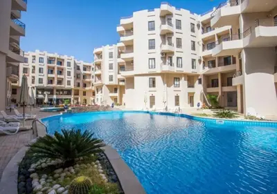 a swimming pool in front of some apartment buildings at Luxury One-Bedroom Apartment Near El Gouna in Hurghada