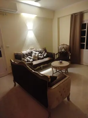 a living room with a couch and a table at Villa-Djorf Westbank in Al Aqālitah